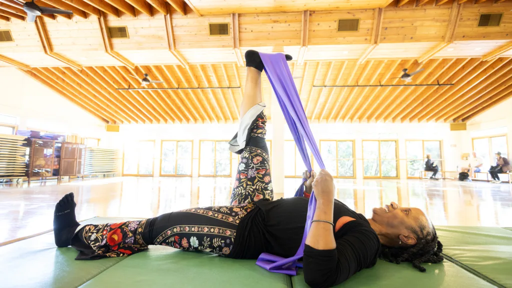 Fitness Instructor Coco using Mobility Stick io her stretch strength